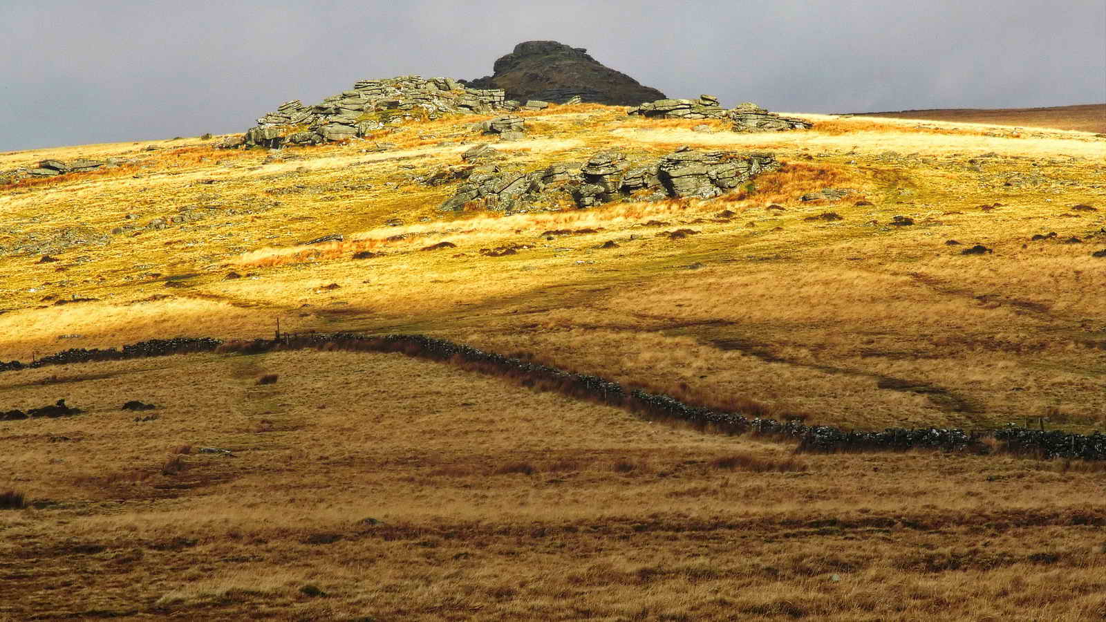 A view of Littaford Tors ahead, with Longford Tor behind in shadow